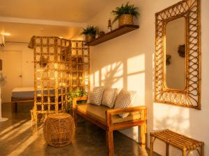 a living room with a bench and a mirror at Hiraya Apartments in San Vicente