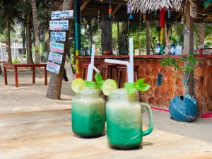 two mason jars filled with green drinks on a table at Happy Beach hotel nilaveli in Nilaveli
