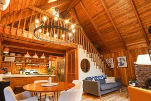 a kitchen and living room with a table and chairs at Sweet Seclusion in Glacier