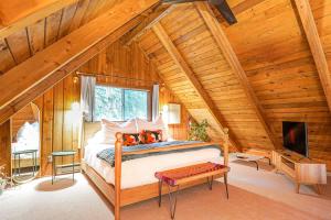 a bedroom with a bed in a wooden attic at Sweet Seclusion in Glacier