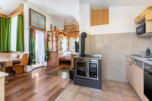 a kitchen with a stove in the middle of a room at Pferdeblick Hütte auf der Rodeoranc in Rottenmann