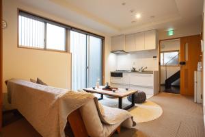 a living room with a table and a kitchen at 宿坊 正伝寺 Temple hotel Shoden-ji in Tokyo