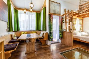 a room with green curtains and a table and a bed at Pferdeblick Hütte auf der Rodeoranc in Rottenmann