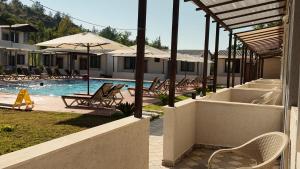 a swimming pool with chairs and umbrellas in a resort at Arsuz Suite House in Arsuz