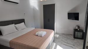 a bedroom with a bed with a towel on it at Arsuz Suite House in Arsuz
