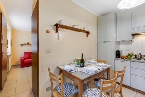 a kitchen and dining room with a table and chairs at Maison Dolce Vento - Happy Rentals in Oulx