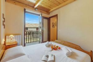 a bedroom with a bed with a view of a balcony at Maison Dolce Vento - Happy Rentals in Oulx +16 photos