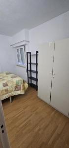 an empty room with a bed and a closet at studio world romer in Costa da Caparica +5 photos