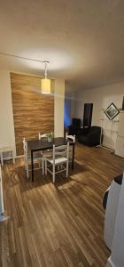 a living room with a table and chairs and a couch at studio world romer in Costa da Caparica