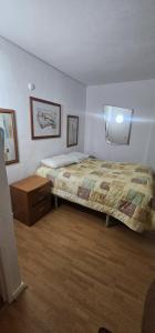 a bedroom with a bed and a dresser in it at studio world romer in Costa da Caparica