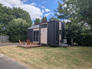 a tiny house sitting on top of a yard at Rosemont Retreat by Tiny Away in Bessé-sur-Braye