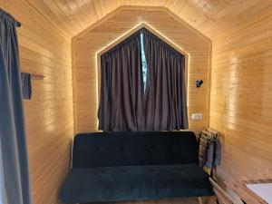 a couch in a room with a window at Rosemont Retreat by Tiny Away in Bessé-sur-Braye