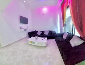 a living room with a couch and a table at Hammamet sunrise in Hammamet
