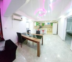 a living room with a table and a kitchen at Hammamet sunrise in Hammamet