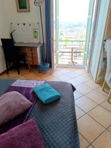 a bedroom with a bed and a desk and a window at Double room with great view in Nice