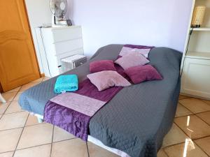 a bed with purple and pink pillows on it at Double room with great view in Nice +19 photos
