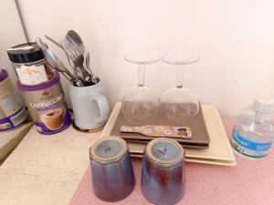 a table with two wine glasses and utensils at Double room with great view in Nice