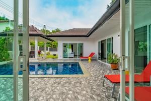 a villa with a swimming pool and a house at Chalong - 4 Bedroom Private Pool Villa - Phuket in Chalong +47 photos