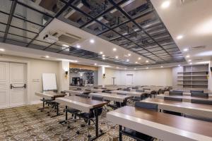 a classroom with tables and chairs and a whiteboard at Reo Hotel in Antalya +61 photos