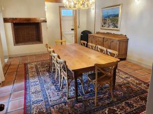 a dining room with a wooden table and chairs at Maskam Manor in Vanrhynsdorp