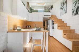 a kitchen with white cabinets and a staircase at Villa 52 Naturiste in Cap d'Agde +9 photos