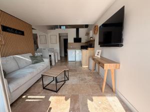 a living room with a couch and a table at Sexty-nine, villa 69 héliovillage in Cap d'Agde