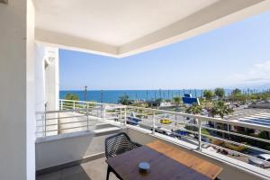 a balcony with a table and a view of the ocean at Reo Hotel in Antalya