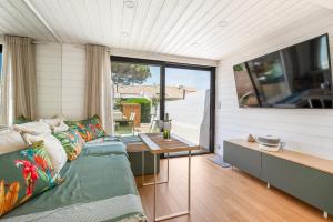a living room with a couch and a table at Villa 52 Naturiste in Cap d'Agde