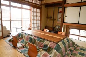 ein Zimmer mit einem großen Holztisch und Stühlen in der Unterkunft かんさんのお宿 in Fuji + 76 Fotos