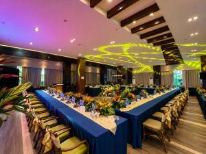 a long dining room with blue tables and chairs at Arterra Hotel and Resort in Mactan +43 photos