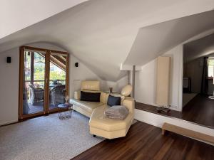 a living room with a couch and a table at Haus am Bach in Roitham