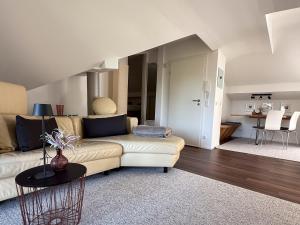 a living room with a couch and a table at Haus am Bach in Roitham