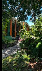 a house with a garden in front of it at Wildfarms resort in Masinagudi