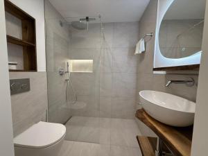 a bathroom with a sink and a toilet and a shower at Lorez 5A by Arosa Holiday in Arosa