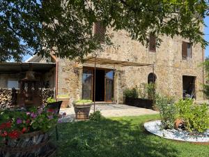 a stone house with a garden in the yard at Domus Olea BnB in Roccatederighi