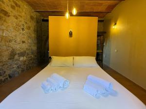a bed in a room with two towels on it at Domus Olea BnB in Roccatederighi