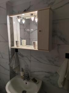 a bathroom with a sink and a cabinet above a mirror at Billias House in Vourvourou +123 photos