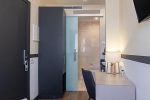 a door leading into a room with a table and chair at May Ramblas Hotel in Barcelona