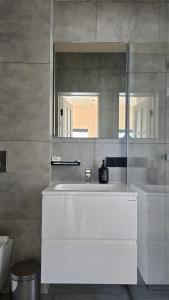 a bathroom with a white sink and a mirror at Magurka Space in Verkhovyna