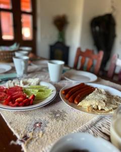 a table with plates of food on top at Pensiunea Cambiano in Beliş +9 photos