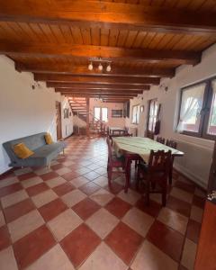 a living room with a table and chairs at Pensiunea Cambiano in Beliş