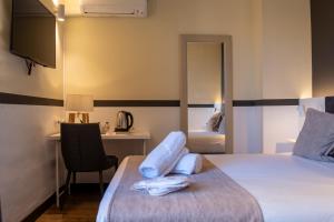 a bedroom with a bed and a desk and a mirror at May Ramblas Hotel in Barcelona +57 photos