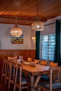 a dining room with a wooden table and chairs at Hakuna matata villas & hostels in Arusha