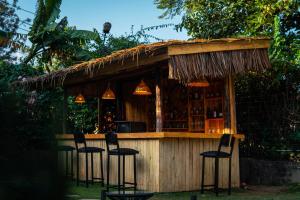 a bar with stools in front at Hakuna matata villas & hostels in Arusha
