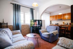 a living room with two couches and a tv at Apartments Stevo Nikočević in Bar