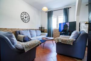 a living room with two couches and a flat screen tv at Apartments Stevo Nikočević in Bar