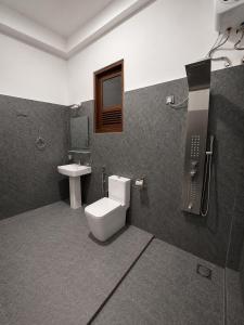 a bathroom with a toilet and a sink at Prabha Garden Boutique Villa in Anuradhapura