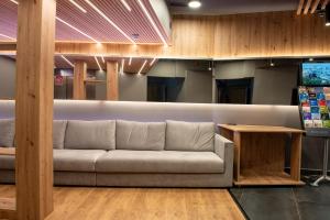 a living room with a couch and a table at May Ramblas Hotel in Barcelona