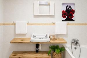a bathroom with a sink and a bath tub at Hakuna matata villas & hostels in Arusha