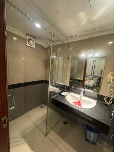 a bathroom with a sink and a mirror at Crown Luxury Hotel in Hanoi